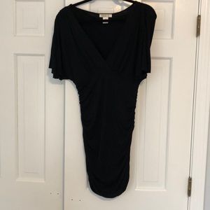 Black fitted top with plunging neckline.